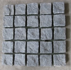 cube on mesh-rock face